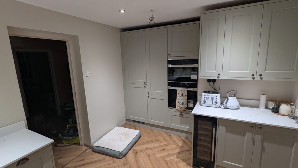 Howdens Sage Green kitchen tall floor to ceiling cupboards