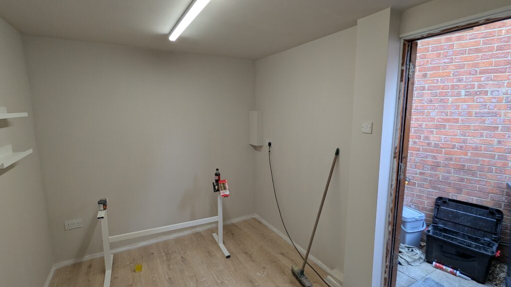 Fully finished garage conversion with wall furnishings added