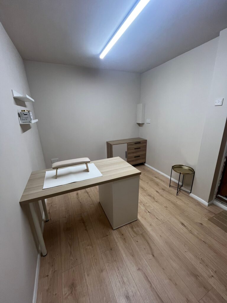 Left view of garage conversion with desk and storage unit