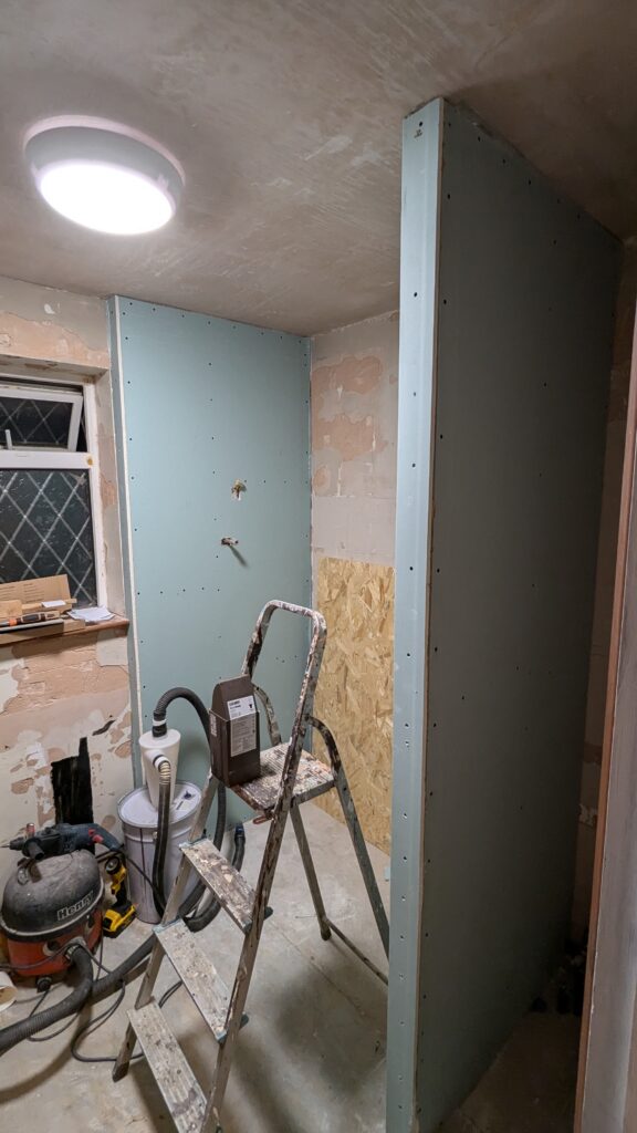 green plasterboarded stud walling